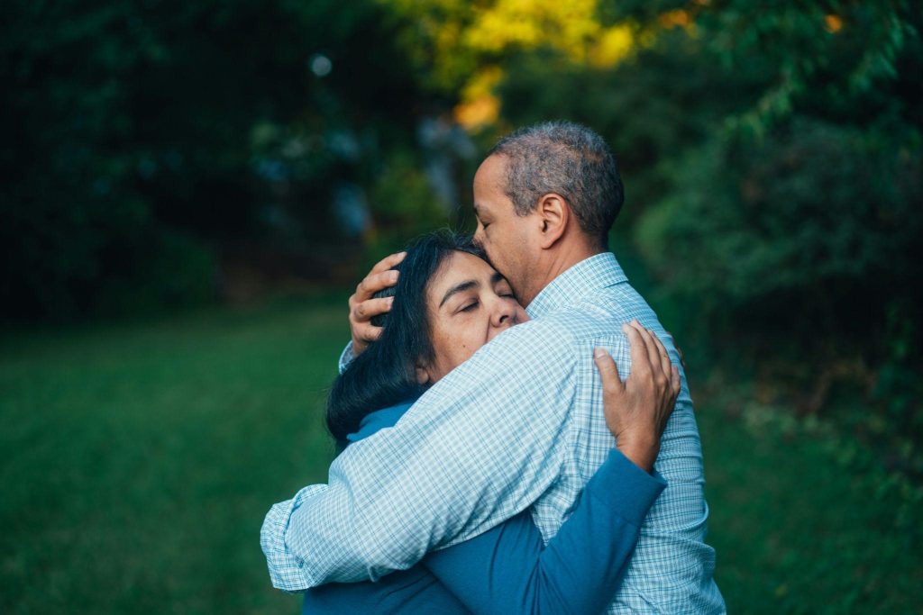 Two people embracing, conveying acceptance and forgiveness.